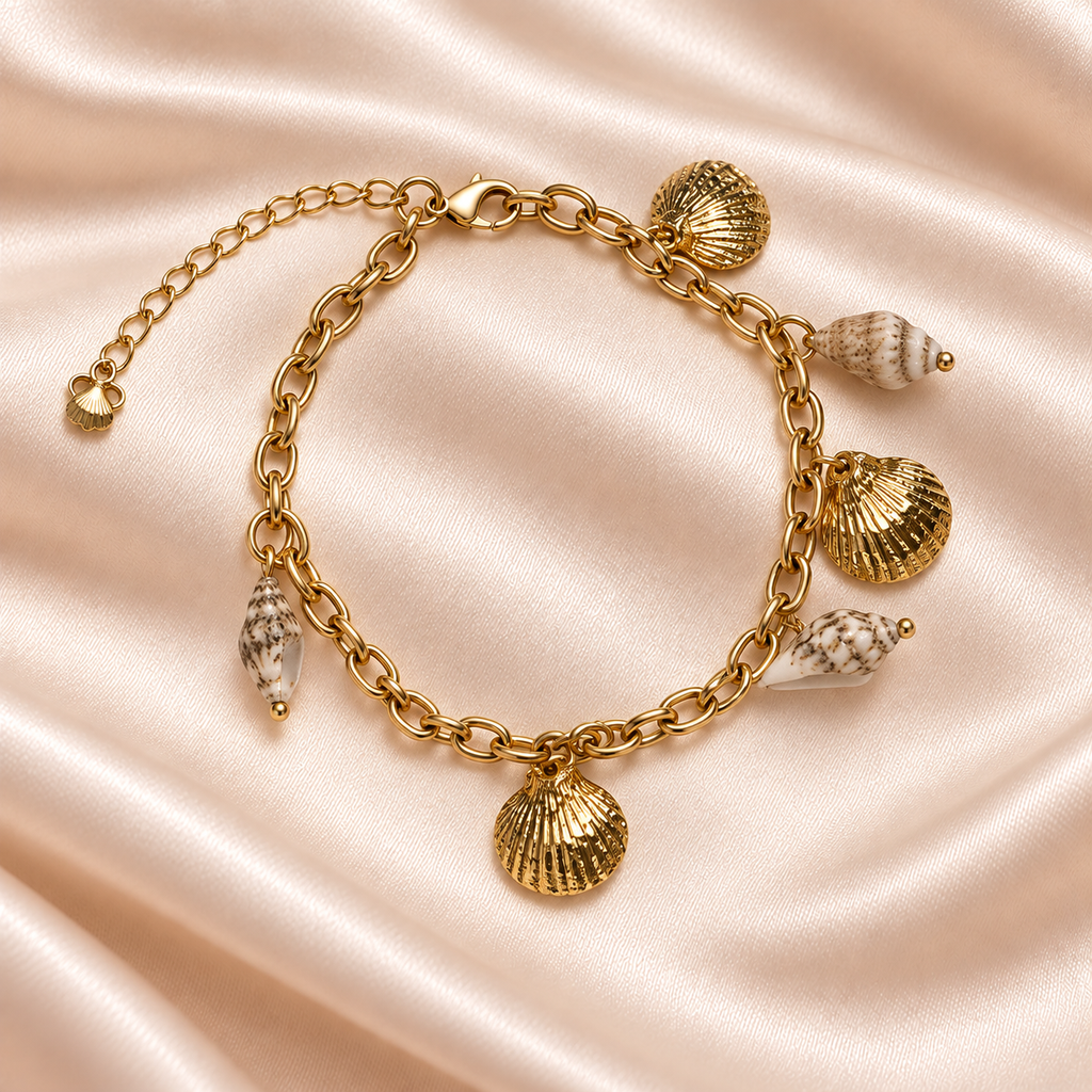 Seashell Treasures Charm Bracelet on pale champagne satin, showing gold scallop charms, cream shell-look accents, oval links and extender.