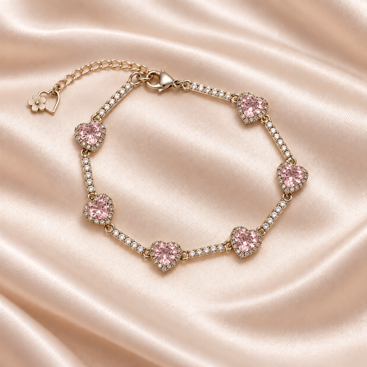 Blush Heart Sparkle Bracelet on pale champagne satin, showing six pink hearts, clear sparkling bar links, clasp and extender.