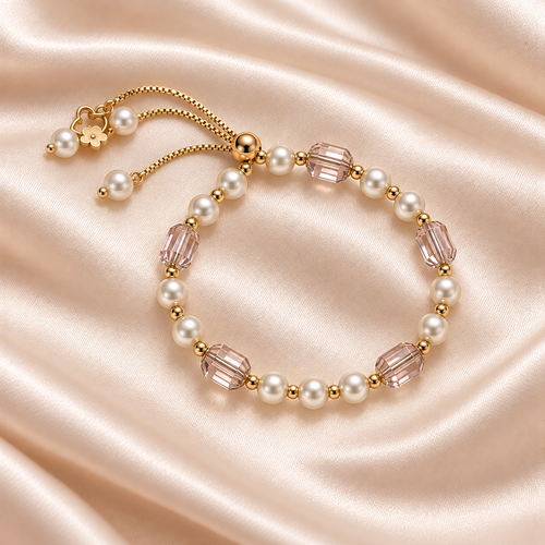 Blush Faceted Bead & Pearl-Style Bracelet on pale champagne satin, showing white beads, blush faceted accents, gold spacers and adjustable slider.