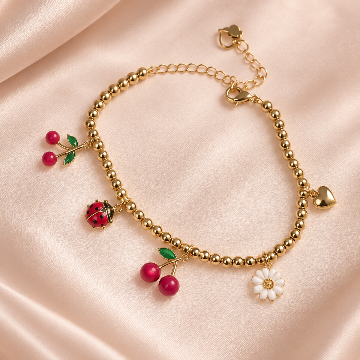 Gold-tone beaded Cherry Garden Charm Bracelet with two cherry charms, a ladybug, white daisy, and heart on cream satin.
