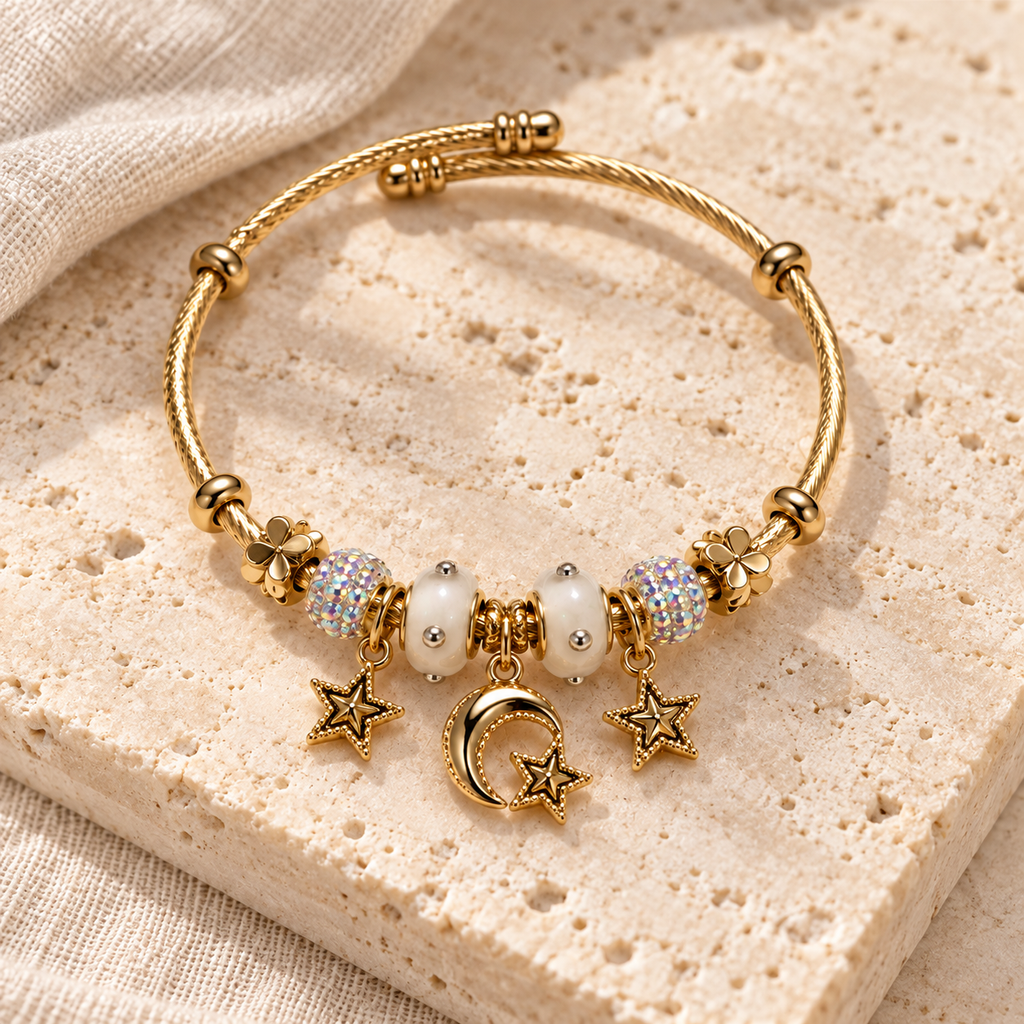 Moon & Star Bead Cuff Bracelet styled on ivory stone and linen, with the complete overlapping wire cuff and celestial charms visible.
