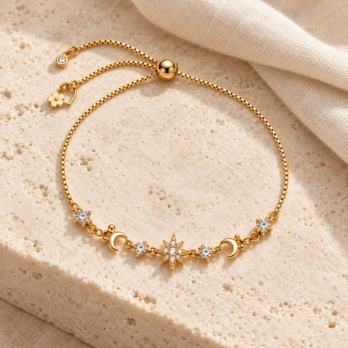 Celestial Sparkle Slider Bracelet styled on warm ivory stone and cream linen, with gold-tone crescents, clear accents and a starburst center.
