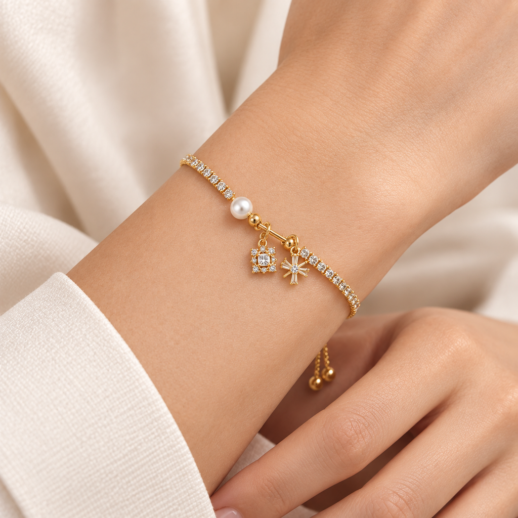 Close-up of the Golden Sparkle Charm Slider Bracelet adjusted snugly around a wrist, showing its pearl-style bead and small sparkling charms.