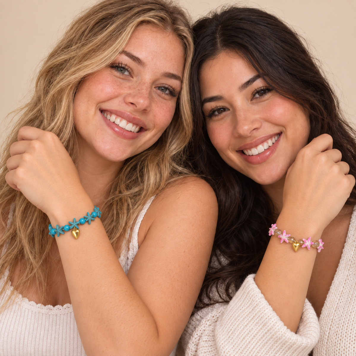 Two full-face friends modeling matching blue and pink Starfish Friendship Bracelets, each bracelet worn around a wrist with a gold-tone half-heart.