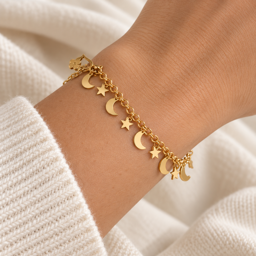 Close-up of Golden Moon & Stars bracelet on a model wrist, showing gold-tone chain and celestial charms