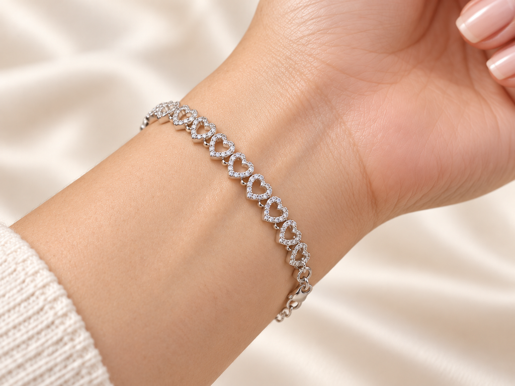 Close-up of sparkling silver open heart links fastened around a wrist