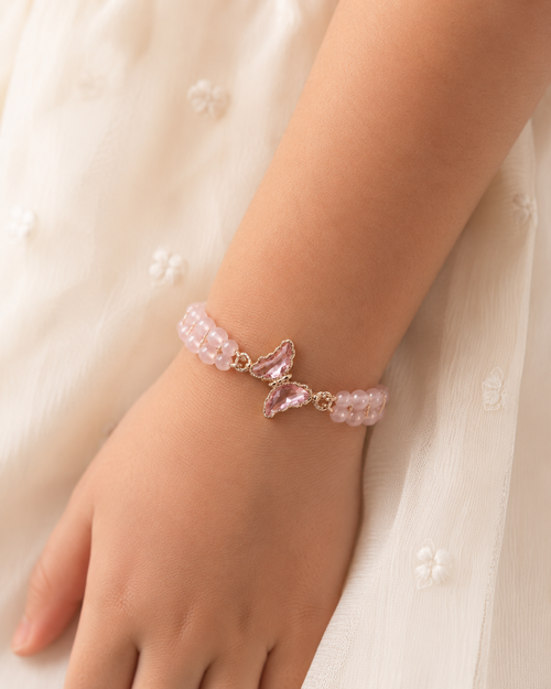 Blush Butterfly Bracelet with pink beads and butterfly centerpiece worn on wrist.