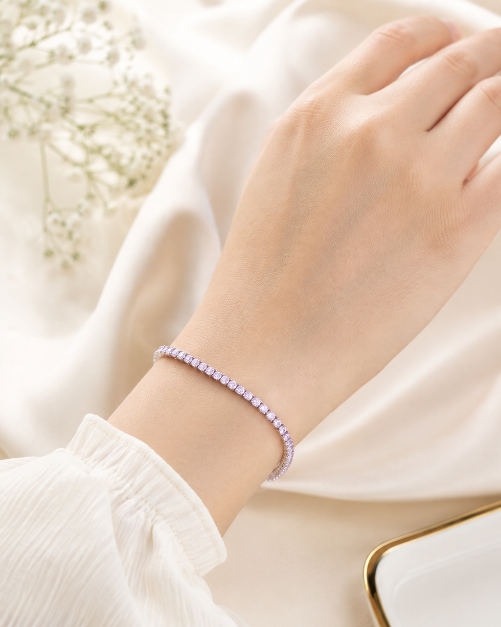 Blush Shimmer Bracelet with pastel pink and lavender stones in a silver-tone setting worn on wrist.