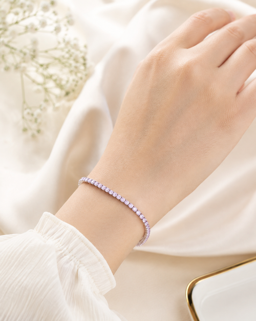Blush Shimmer Bracelet with pastel pink and lavender stones in a silver-tone setting worn on wrist.