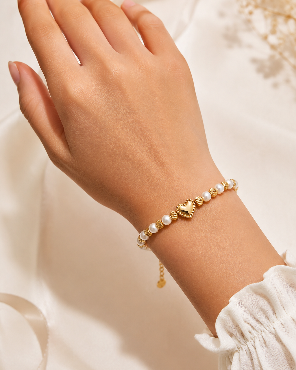 Golden Pearl Heart Bracelet with pearl beads, gold swirl spacers, and gold heart charm worn on wrist.