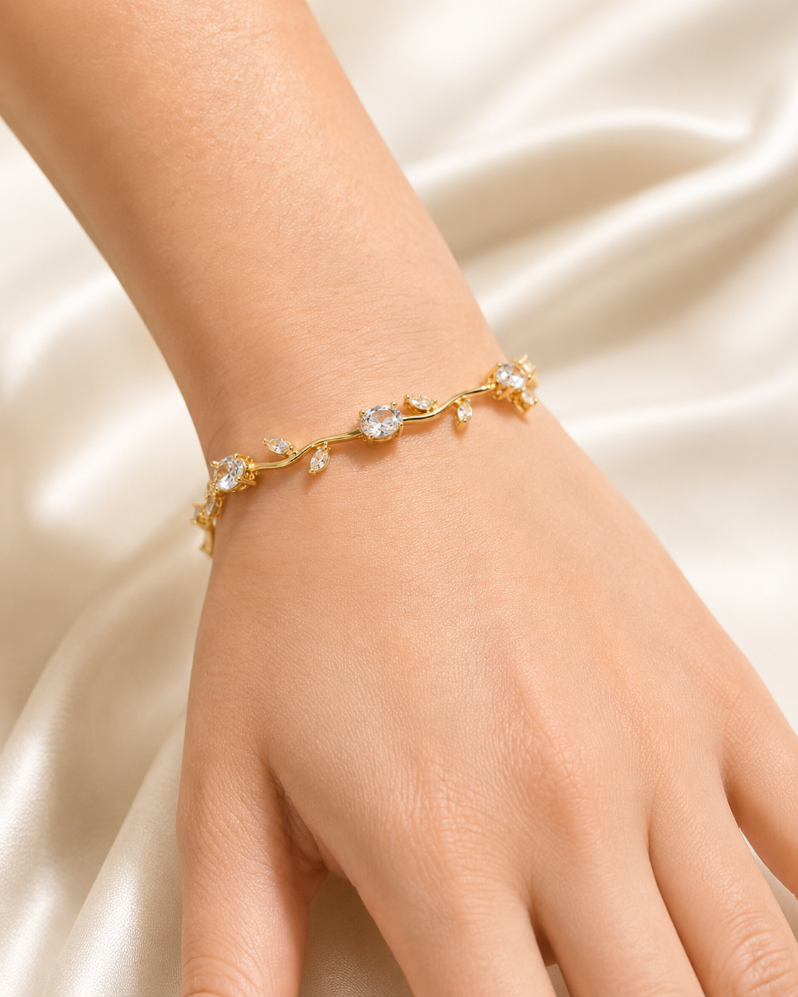 Golden Vine Bracelet with clear crystal stones and delicate gold-tone vine design worn on wrist.

