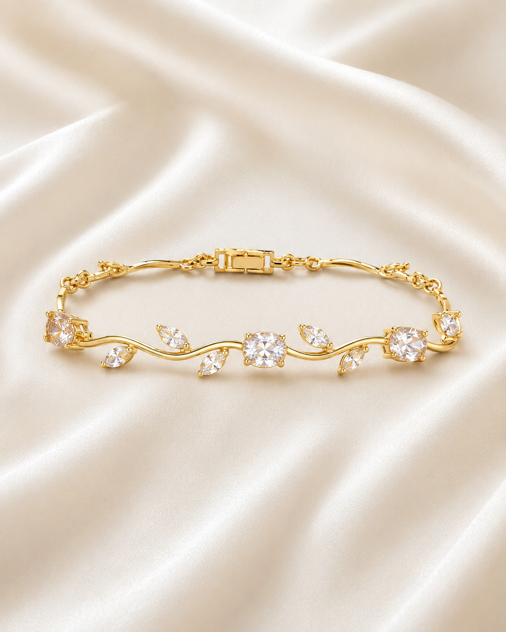 Golden Vine Bracelet displayed on a neutral stone tray with satin fabric and soft floral styling.