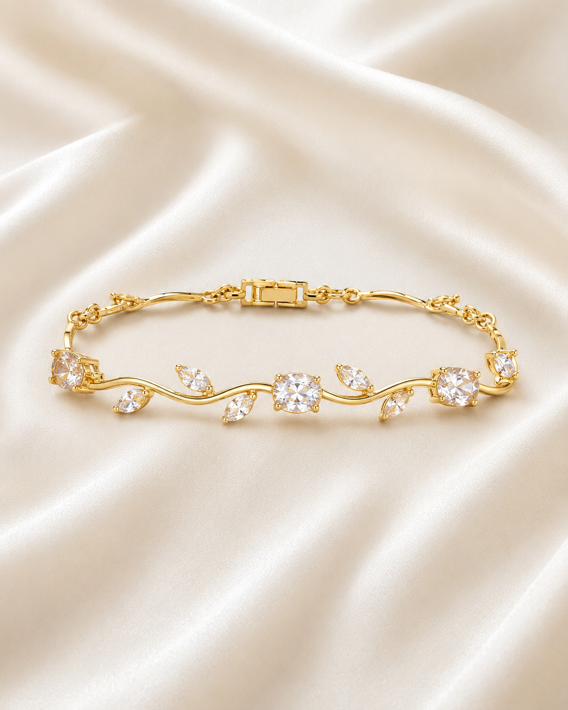 Golden Vine Bracelet displayed on a neutral stone tray with satin fabric and soft floral styling.