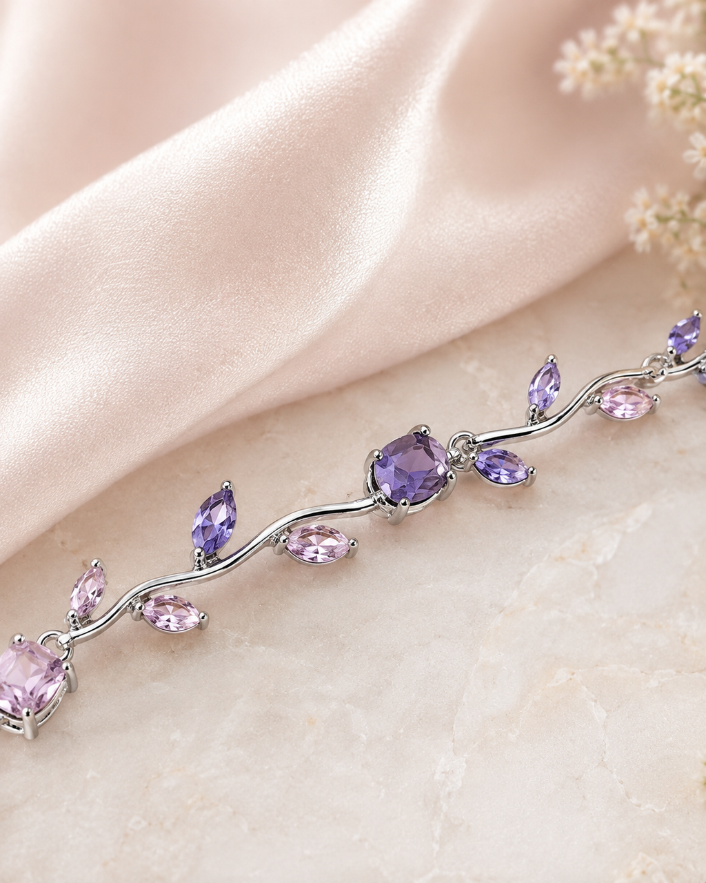 Close-up of Lavender Bloom Bracelet showing pastel pink, lavender, and purple gemstones in a delicate silver-tone vine setting.