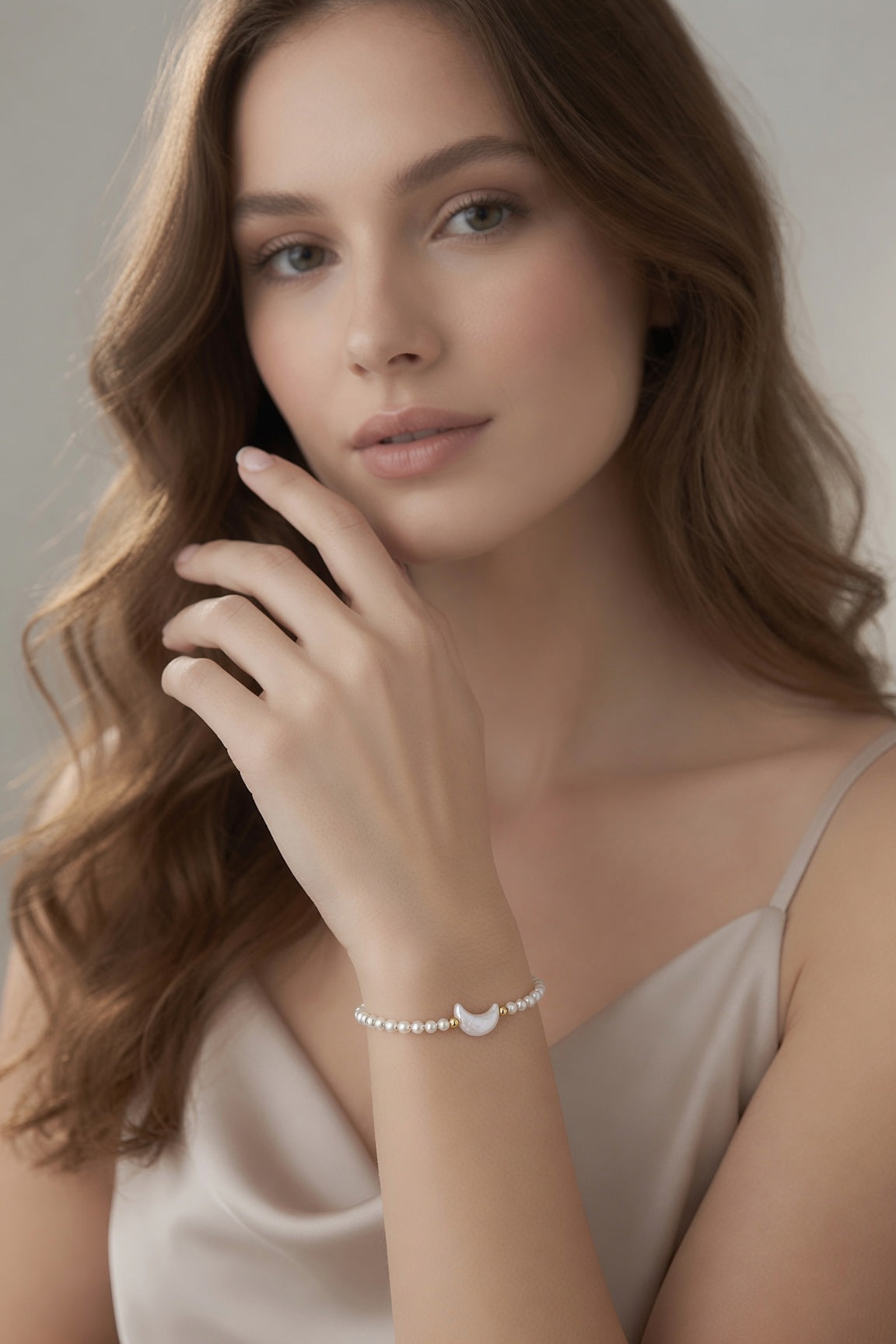 Model wearing the Moonlit Pearl Bracelet with luminous white pearl beads and delicate gold accents from The Ohana Collection.