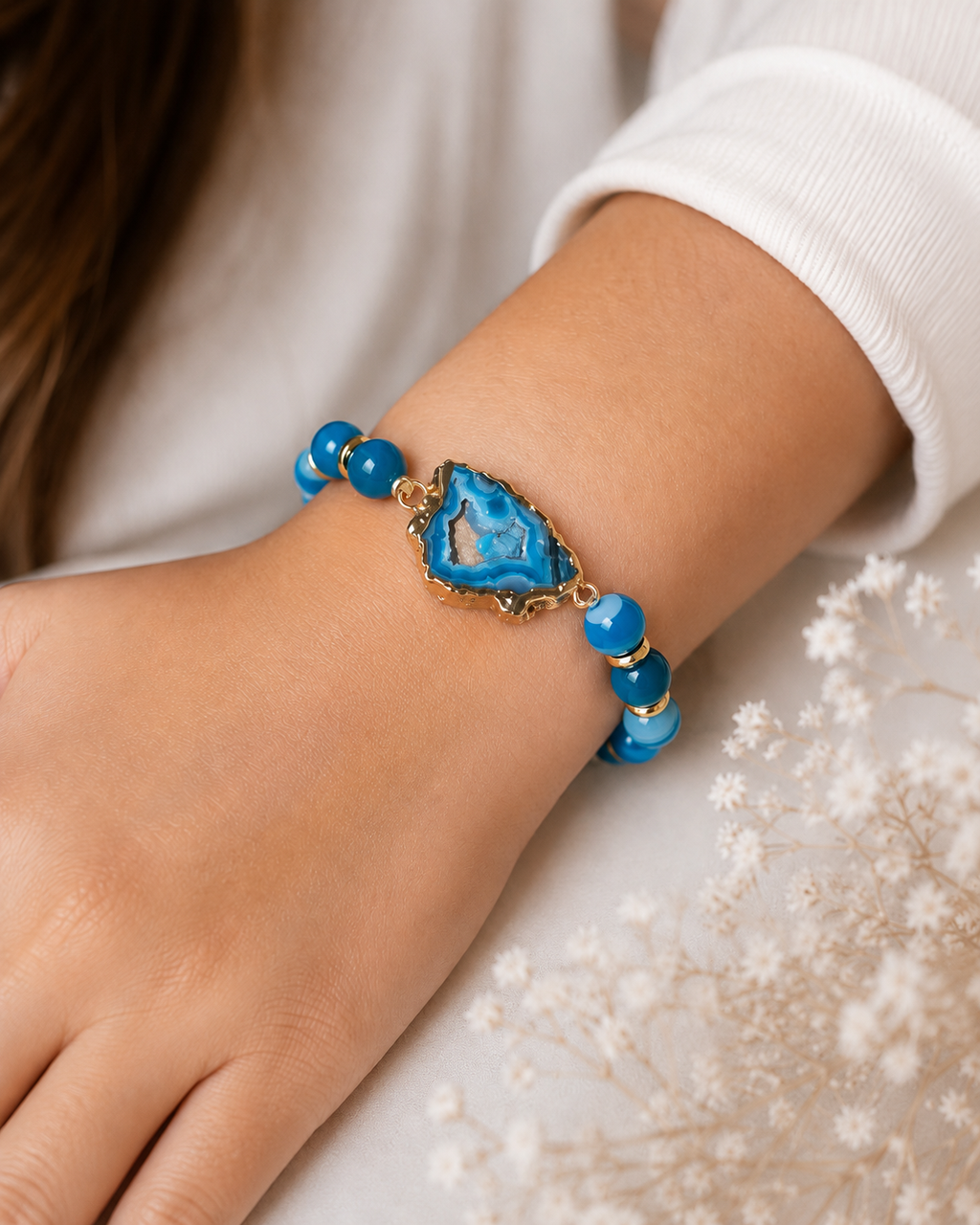 Ocean Glow Agate Bracelet with blue beads, gold accents, and blue agate centerpiece worn on wrist.