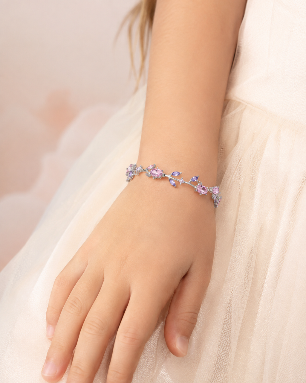 Pastel Garden Bracelet with silver-tone vine details and pastel pink and lavender stones worn on wrist.