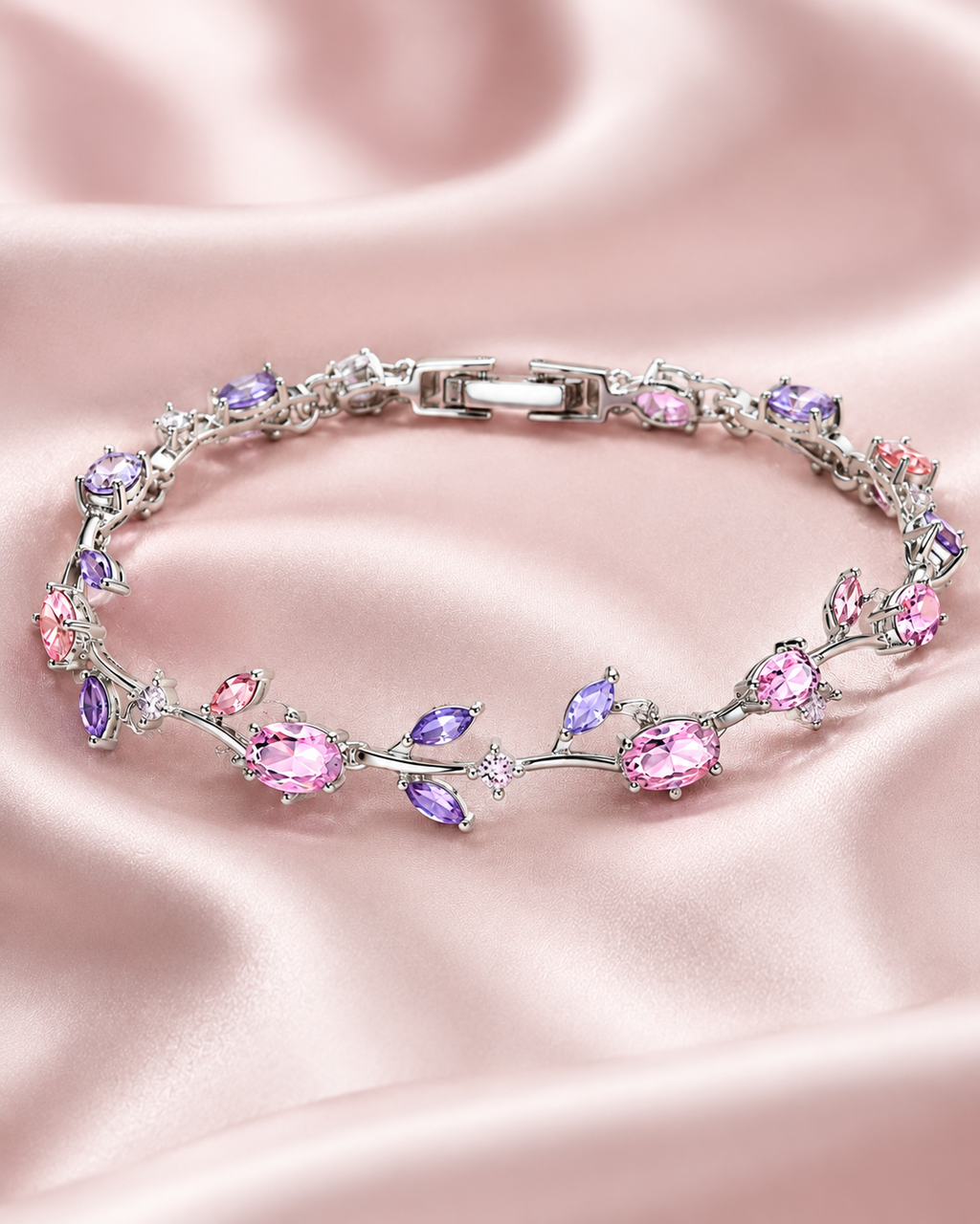 pink Heartstone bracelet with gold-tone links and sparkling pink heart-shaped stones displayed on soft satin fabric.