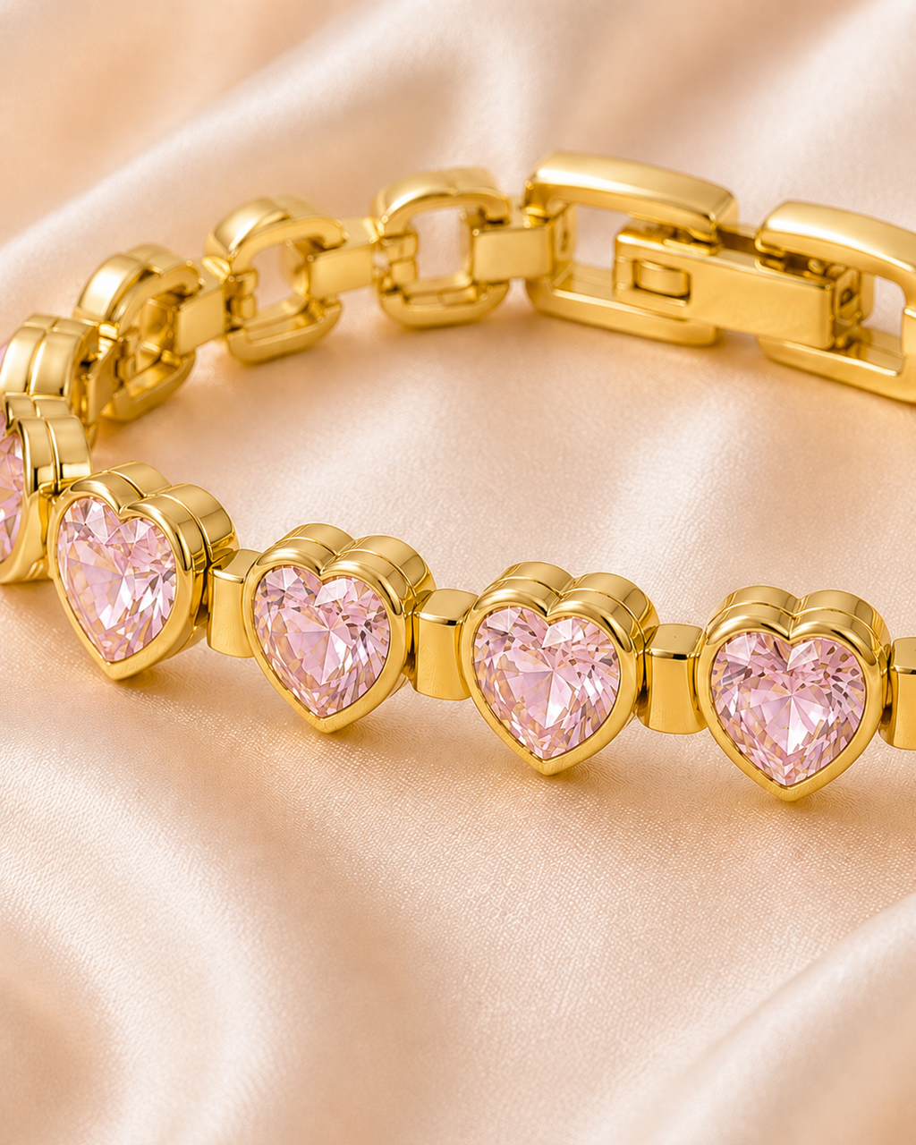 Close-up of Pink Heartstone Bracelet showing faceted pink heart stones in a polished gold-tone setting