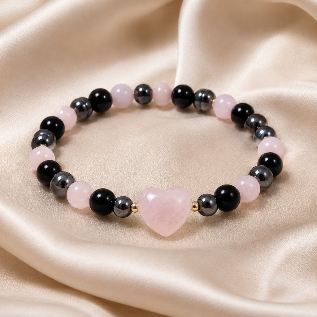Rose Shadow Heart Bracelet with pink heart centerpiece, black beads, gray beads, soft pink beads, and gold accents on satin fabric.